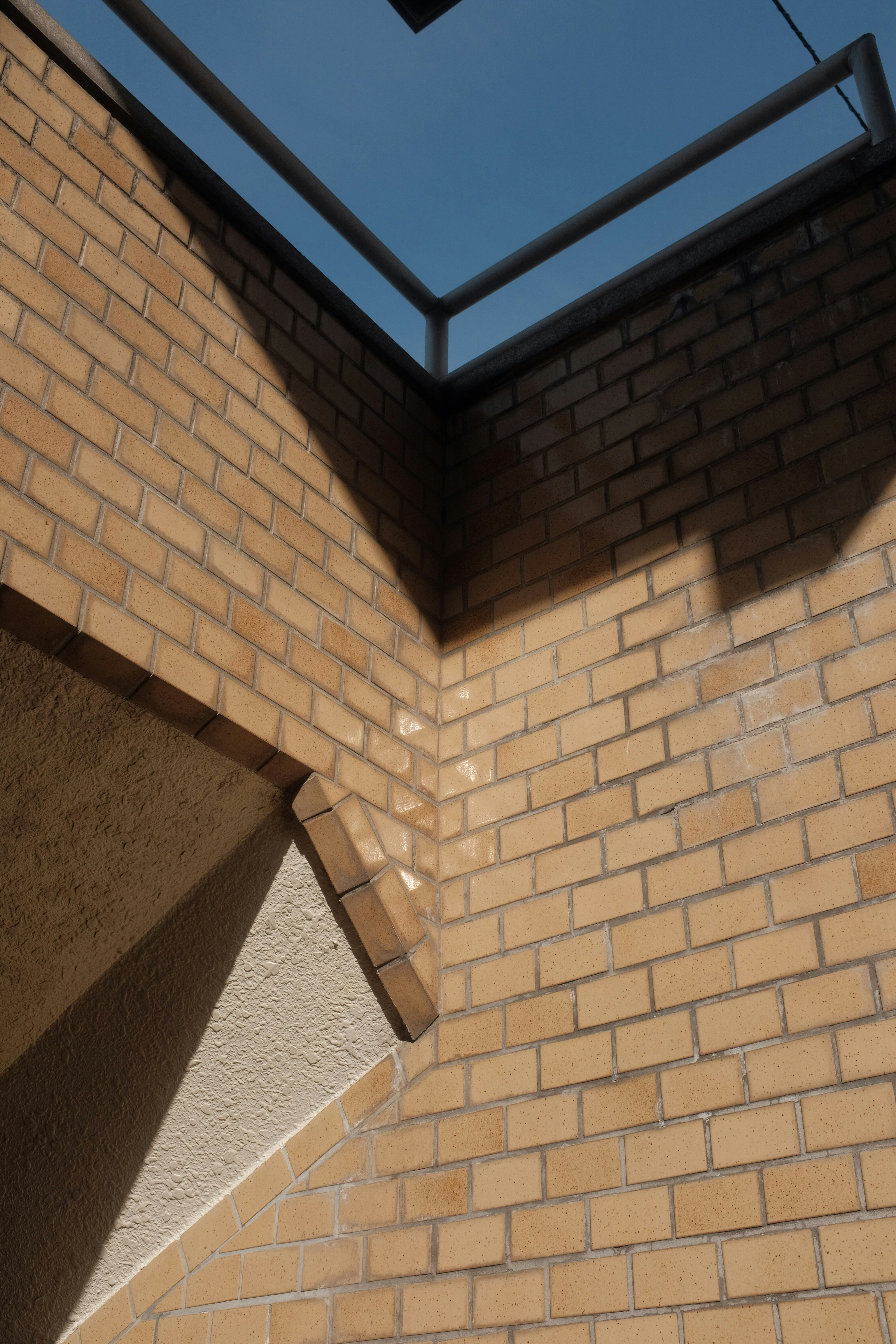 brown brick wall with blue glass window